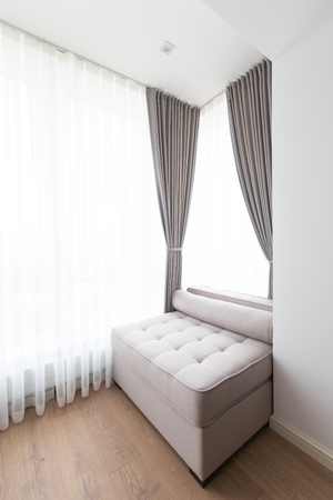 Sofa in a modern room next to a windowの写真素材