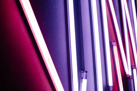 Neon lights. Light colorful blue and red neon lights over dark backgroundの写真素材