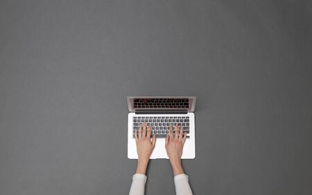 Woman working using a laptop. Overhead image of a business womanの写真素材