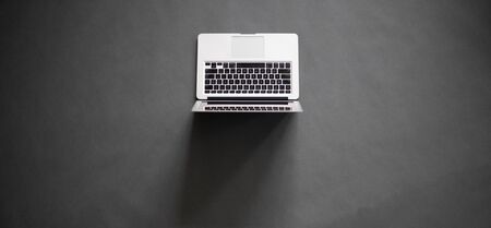 Laptop over gray table overhead imageの写真素材