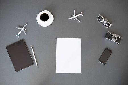 White sheet of paper for your text. Overhead view with travel items around itの写真素材