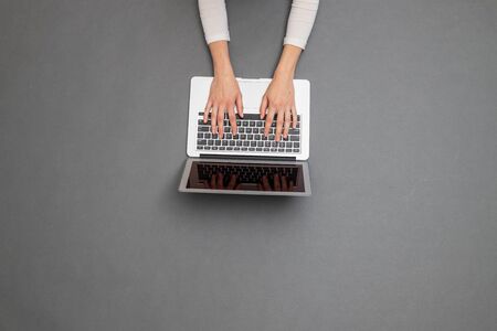 Woman working using a laptop. Overhead image of a business womanの写真素材