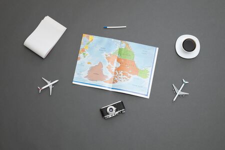 World map over gray table with toy airplanesand a coffee cupの写真素材