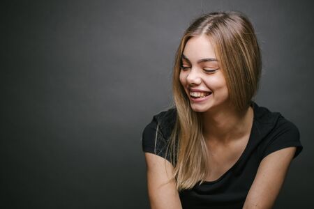 Fashion portrait of a sexy blonde woman with a make up wearing black clothesの写真素材