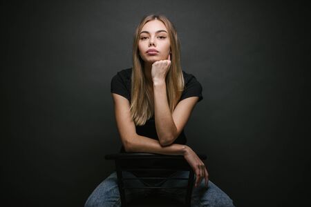 Fashion portrait of a sexy blonde woman with a make up wearing black clothesの写真素材