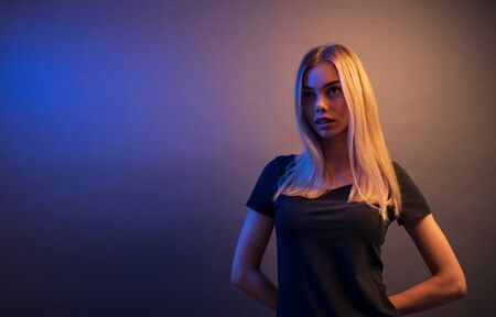 Fashion headshot of a sexy blonde woman with a make up wearing black clothesの写真素材