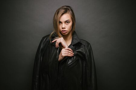 Fashion headshot of a sexy blonde woman with a make up wearing black clothesの写真素材