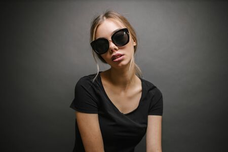 Fashion portrait of a sexy blonde woman with a make up wearing black clothesの写真素材