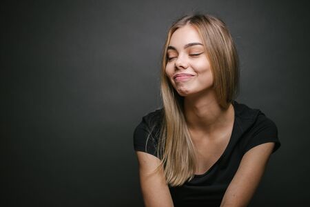 Fashion portrait of a sexy blonde woman with a make up wearing black clothesの写真素材