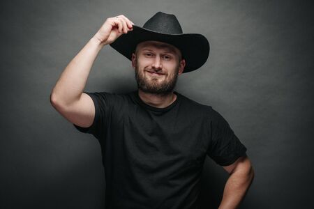 Handsome cowboy wearing black cowboy hat with beardの写真素材