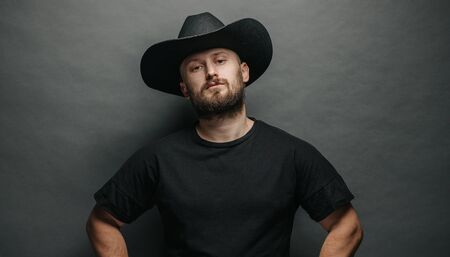 Handsome cowboy wearing black cowboy hat with beardの写真素材