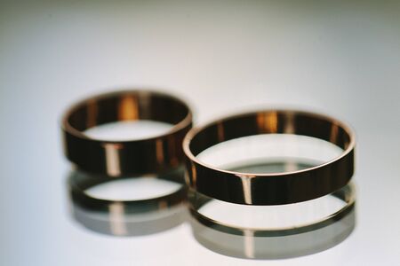Wedding rings on a glass tableの写真素材