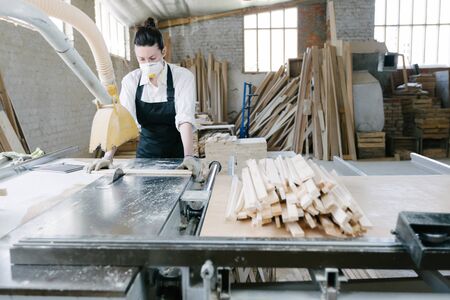 Confident woman working as carpenter in her own woodshopの写真素材
