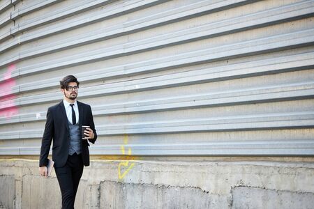 Young Businessman using a tablet pc outside wearing a classic suitの写真素材