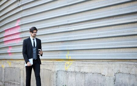 Young Businessman using a tablet pc outside wearing a classic suitの写真素材