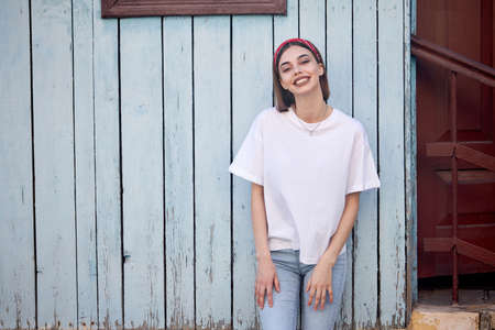 Woman or girl wearing white blank t-shirt with space for your logo, mock up or design in casual urban styleの写真素材