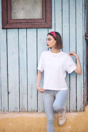 Woman or girl wearing white blank t-shirt with space for your logo, mock up or design in casual urban styleの写真素材