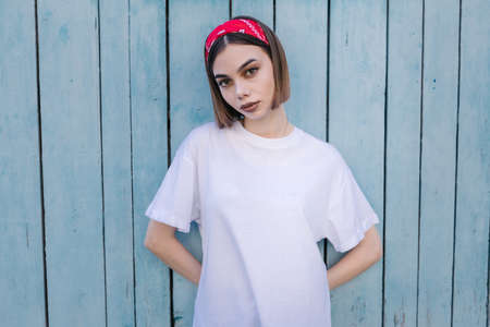 Woman or girl wearing white blank t-shirt with space for your logo, mock up or design in casual urban styleの写真素材