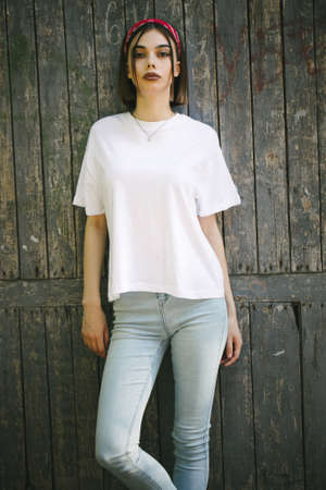 Woman or girl wearing white blank t-shirt with space for your logo, mock up or design in casual urban styleの写真素材