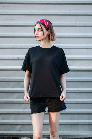 Sexy woman or girl wearing black blank t-shirt with space, mock up or design in casual urban style