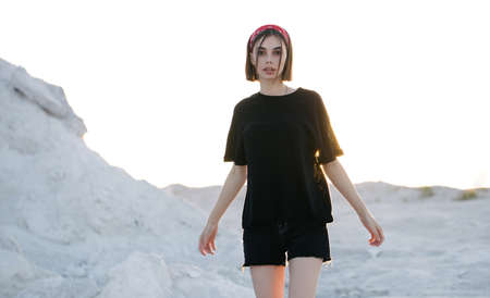 Sexy woman or girl wearing black blank t-shirt with space, mock up or design outdoorsの写真素材