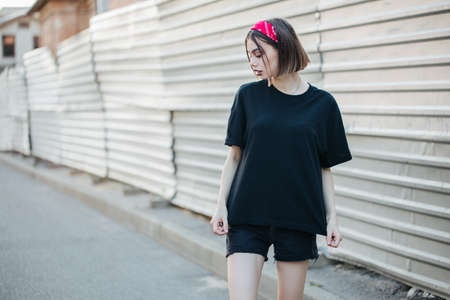 Sexy woman or girl wearing black blank t-shirt with space, mock up or design in casual urban styleの写真素材