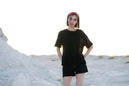 Sexy woman or girl wearing black blank t-shirt with space for your logo, mock up or design outdoorsの写真素材