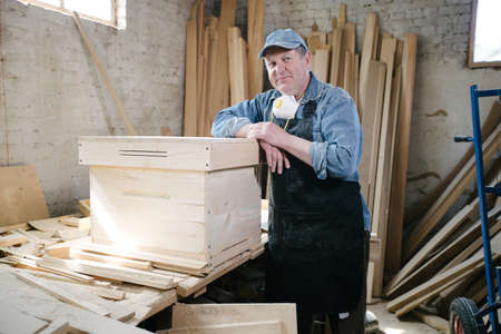Carpenter man posing in carpentry workshopの写真素材