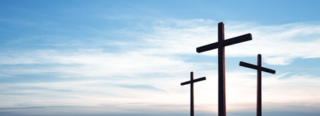 Easter concept. Cross of Jesus Christ empty over dramatic sunrise sky panorama with sclouds.の写真素材