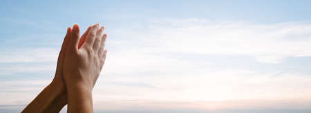 Praying hands. Folded hands in prayer to the sky
