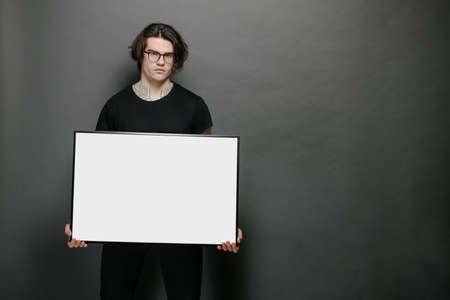 Man holding empty poster in handsの写真素材