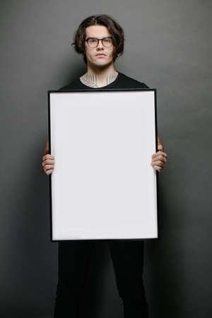 Man holding empty poster in handsの写真素材
