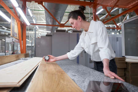 Business woman worker in the carpentry factory using tablet pc. Carpentry factory. Factory for the...