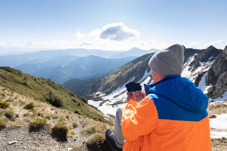 Man flying a drone in the mountains. Pip Ivan peak. Marmarosy ridge, Carpathian, Ukraineの写真素材