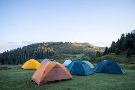 Hiking tents in the mountains set outdoor. Colorful trekking tents outsigeの写真素材