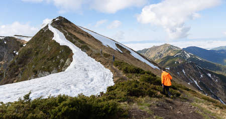 Hiker trekking to the highest ukrainian ridge Marmarosy near Romania. Mountain named Pip Ivan