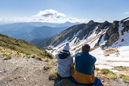 Hikers enjoying high peak view on mountains in summer. Beautiful winter mountain landscape. View of Marmarosy Ridge.の写真素材