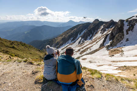 Hikers enjoying high peak view on mountains in summer. Beautiful winter mountain landscape. View of Marmarosy Ridge.の写真素材