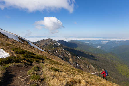 Hiker trekking to the highest ukrainian ridge Marmarosy near Romania. Mountain named Pip Ivanの写真素材