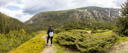 Woman hiker hiking in the mountains in summer to the highest ukrainian ridge Marmarosy near Romania.の写真素材