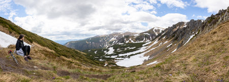 Woman hiker hiking in the mountains in summer to the highest ukrainian ridge Marmarosy near Romania.の写真素材