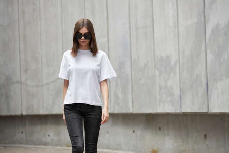 Girl or woman wearing white blank t-shirt with space for your logo, mock up or design in casual...
