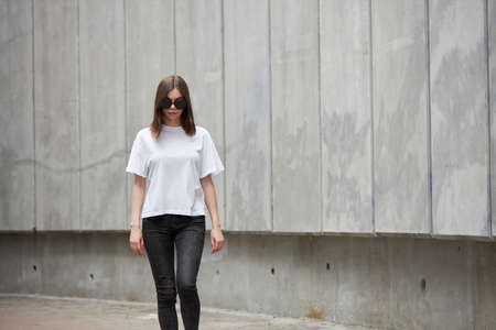Girl or woman wearing white blank t-shirt with space for your logo, mock up or design in casual...