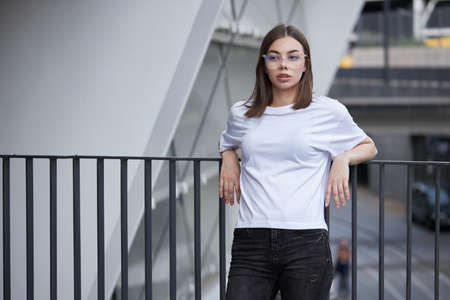 Girl or woman wearing white blank t-shirt with space for your logo, mock up or design in casual urban styleの写真素材