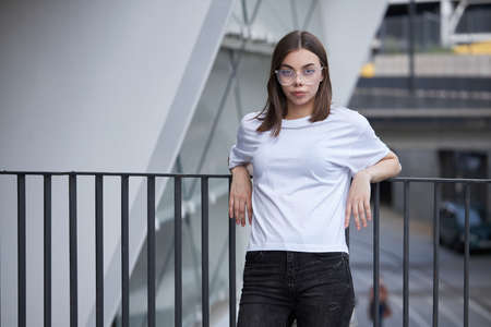 Girl or woman wearing white blank t-shirt with space for your logo, mock up or design in casual urban styleの写真素材