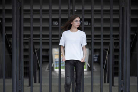 Girl or woman wearing white blank t-shirt with space for your logo, mock up or design in casual urban styleの写真素材