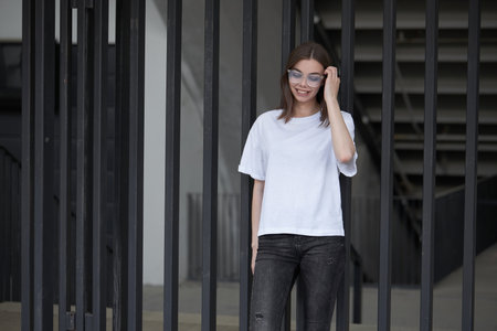 Girl or woman wearing white blank t-shirt with space for your logo, mock up or design in casual urban styleの写真素材