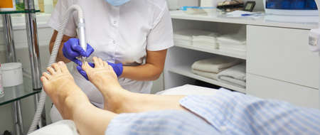 Peeling feet Pedicure SPA procedure in the beauty salon. Electric apparatus for pedicure. Woman getting her feet peeled in spa centerの写真素材