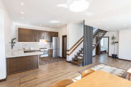 Modern wooden kitchen in scandinavian interior with cooking appliances. Real imageの写真素材