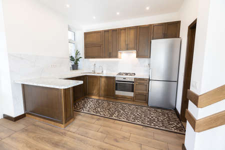 Modern wooden kitchen in scandinavian interior with cooking appliances. Real imageの写真素材